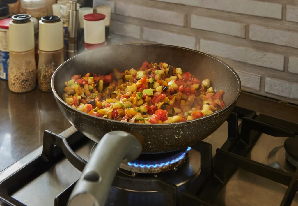 cooking vegetables cottage cheese in a pan